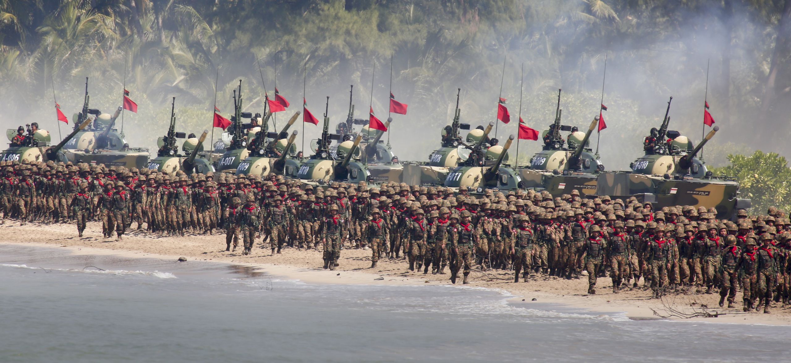 Myanmar military troops and tanks move in formation along the shore during the second day of 'Sin Phyu Shin' joint military exercises in Ayeyarwaddy delta region, on Feb. 3, 2018. (Photo by Lynn Bo Bo/AFP)