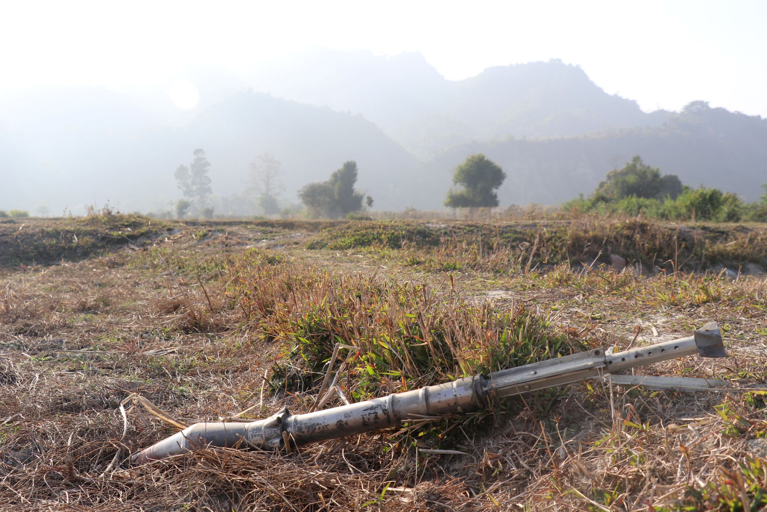 an unexploded ammunition lying on a field in Rathedaung township