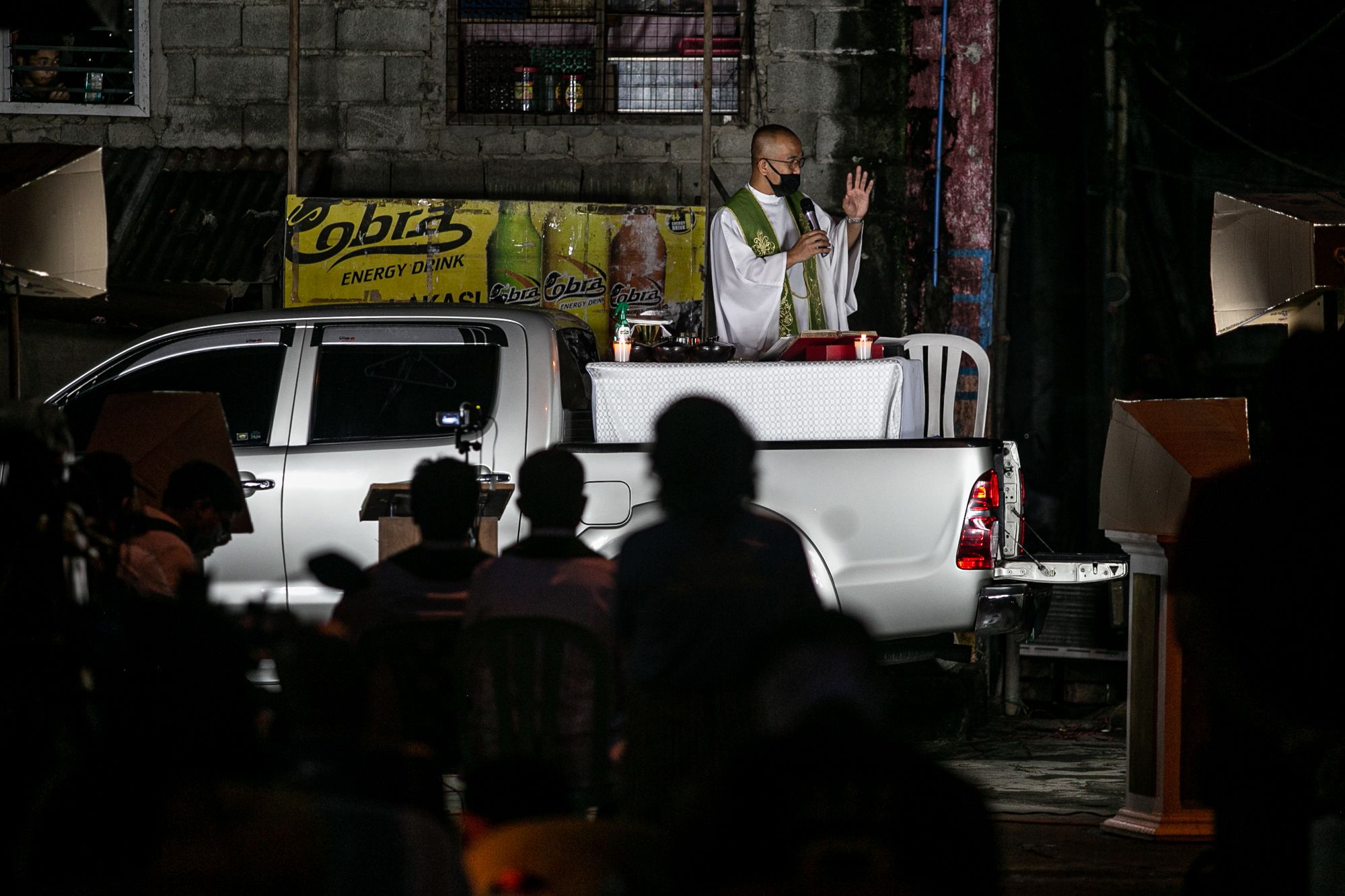 Father Ronald Roberto celebrates Mass on a pick-up truck in Quezon City’s Roxas district on June 2.