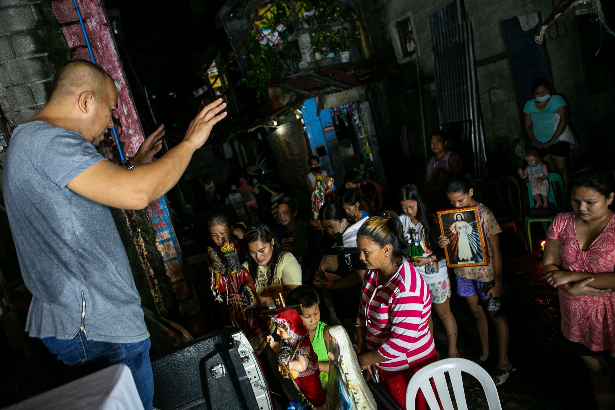Father Ronald Roberto blesses religious images that residents of Roxas district held during the entire celebration.