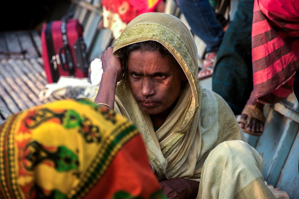 A Rohingya woman crossing a river in a boat beside a rural area near Chittagong city in Bangladesh, Dec. 6, 2017. (shutterstock.com photo)