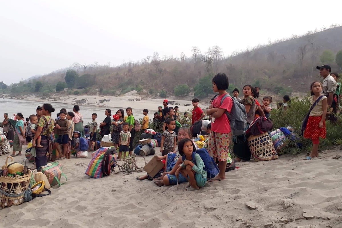 Karen refugees carrying belongings are seen at Salween riverbank in Mae Hong Son, Thailand