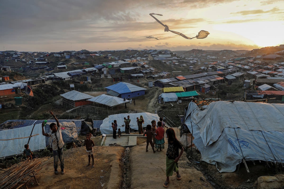 Rohingya refugee children fly improvised kites at the Kutupalong refugee camp