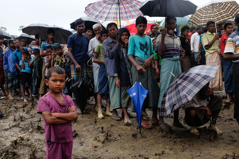 Rohingya refugees queue for a food supplies distribution at the refugee camp Cox Bazaar, Bangladesh