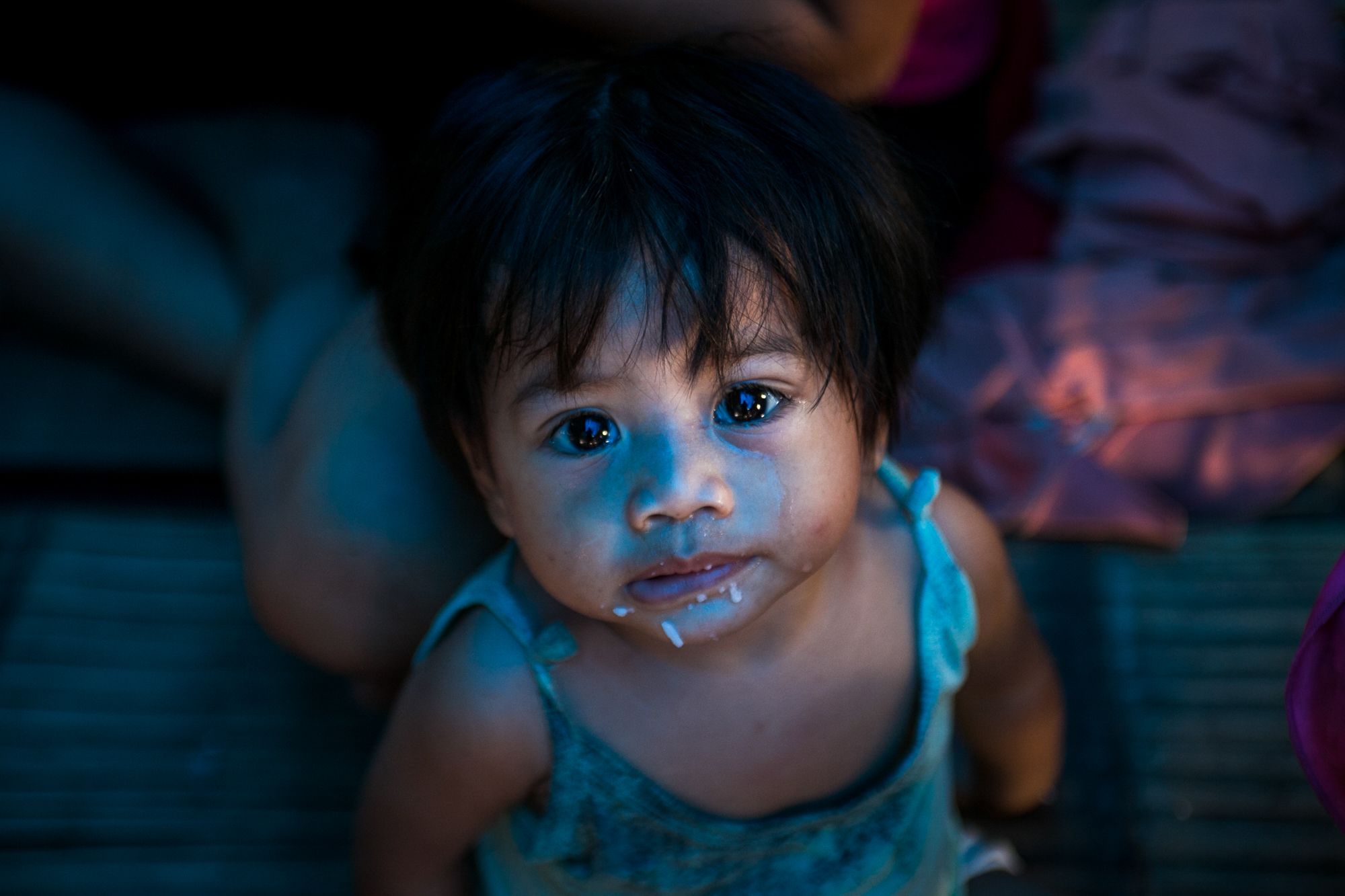 A child cries as she begs for food in this photograph taken in a refugee camp in Cagayan de Oro in 2018.
