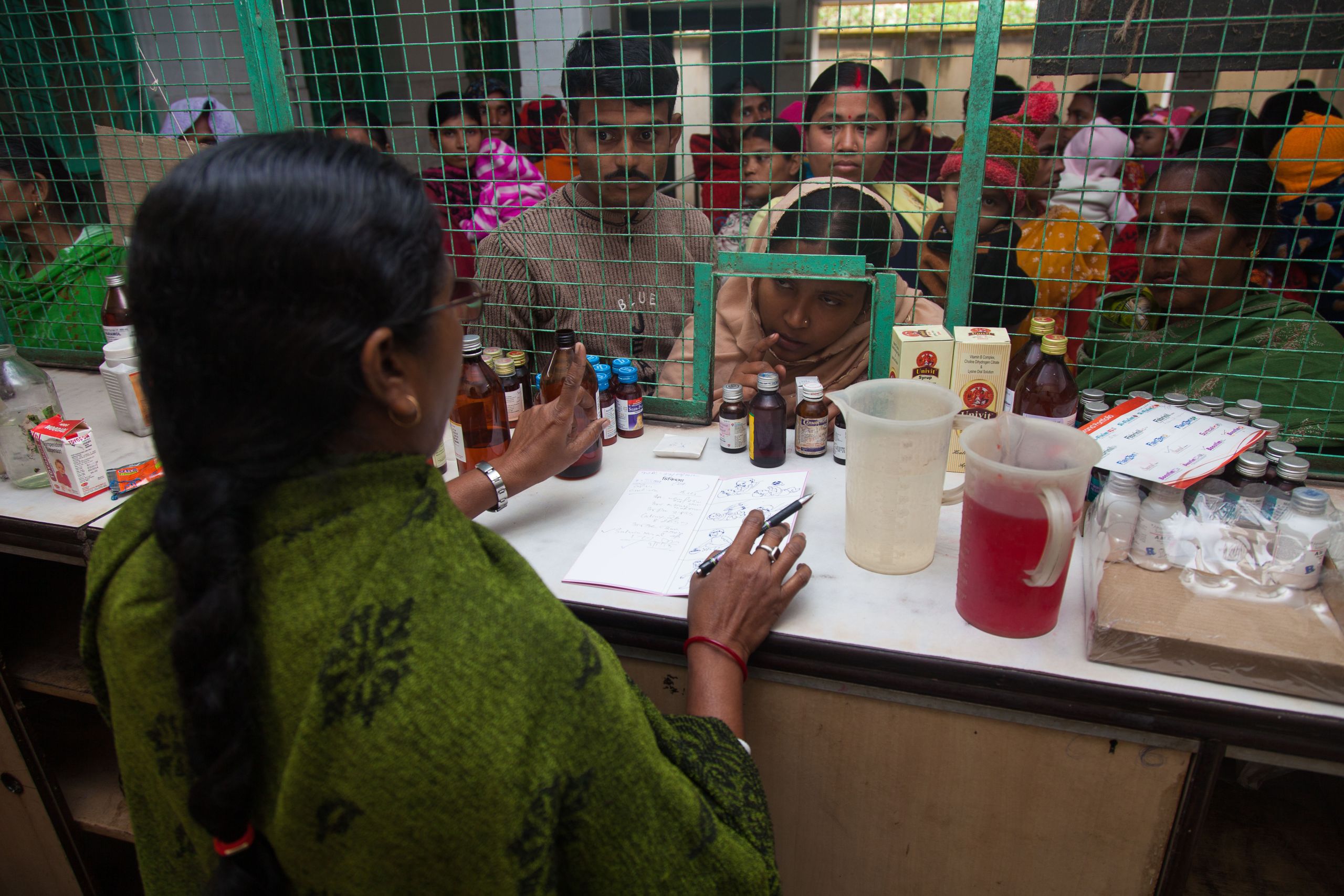 Kolkata, 24 Parganas (S), India - 12th January 2013: Mother and child have come for check up in the clinic / hospital and is queuing in front of outdoor to take medicine against (Photo by Kakoli Dey / Shutterstock.com)