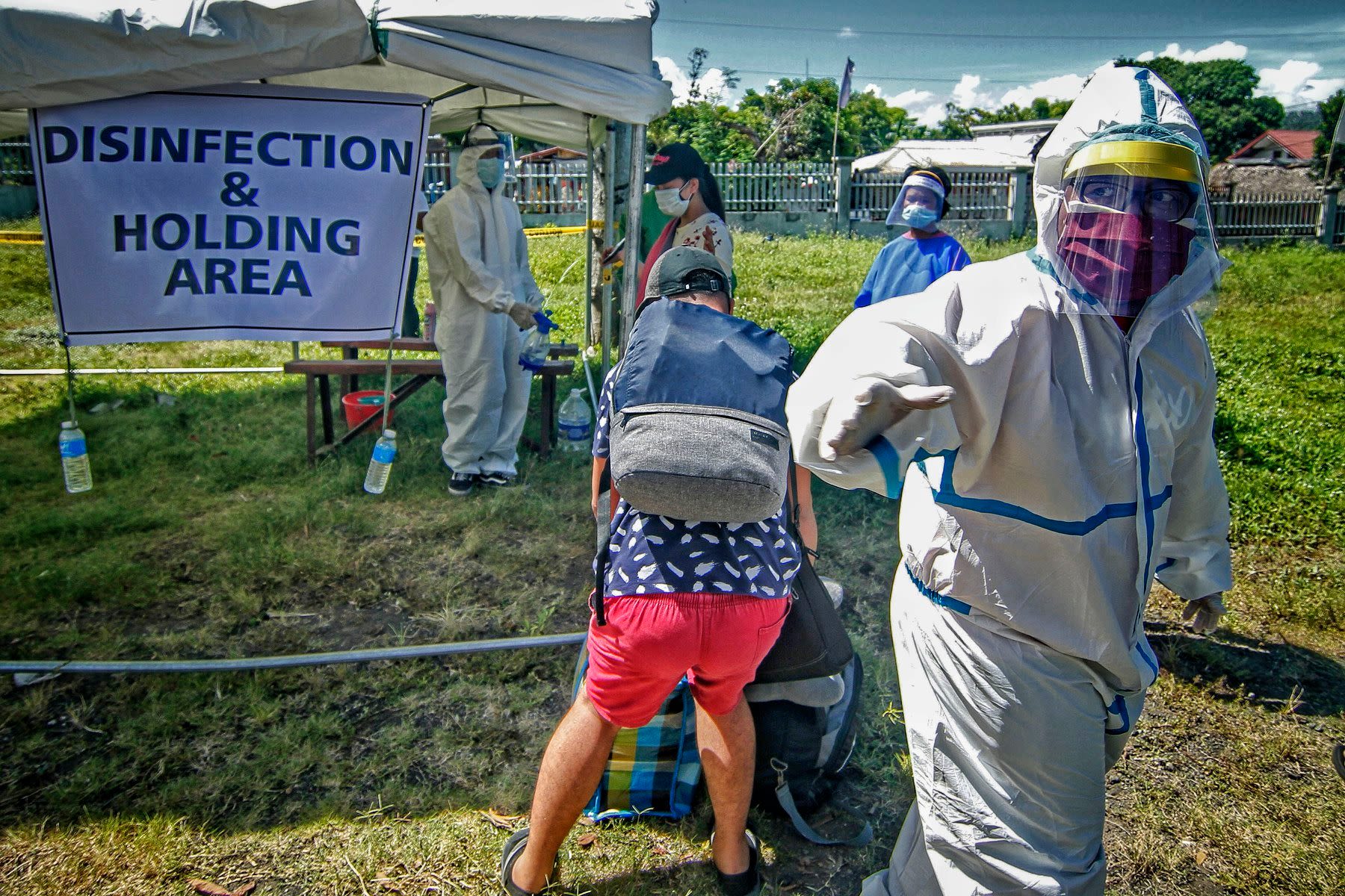A disinfection area for the arriving passengers has been set up in the middle of a vacant lot in the province of Albay.