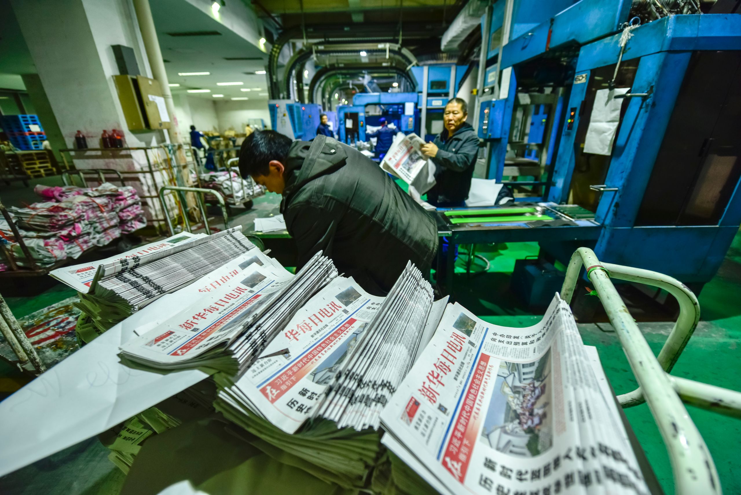 Printing staff from Ren Min Ri Bao, a newspaper aligned with the Chinese Communist Party, at work in a facility in Chengdu, Sichuan, China on Jan. 20, 2019. (shutterstock.com photo)