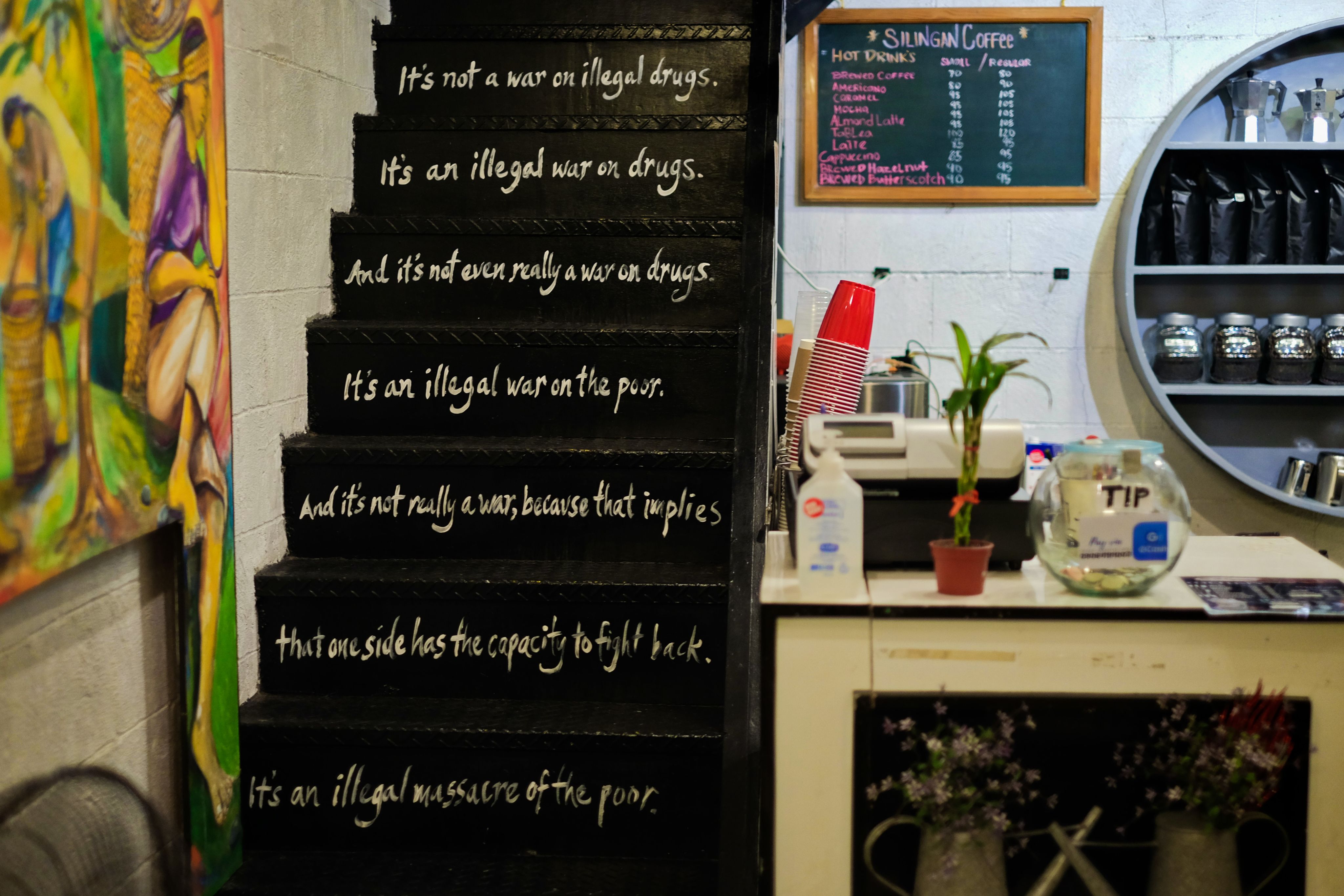 Words on the stairs leading to the second floor of the coffee shop