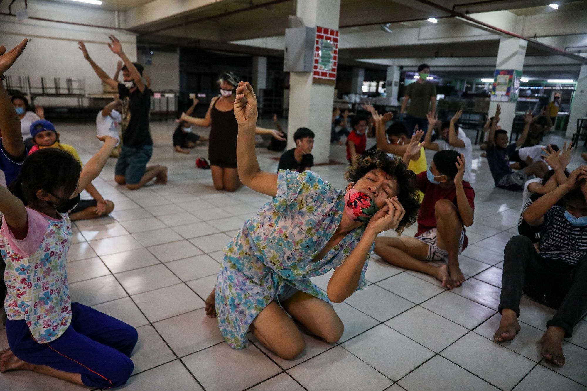 A group of homeless people attend a theater workshop that has been integrated into Kalinga Center's program for street dwellers in Manila.