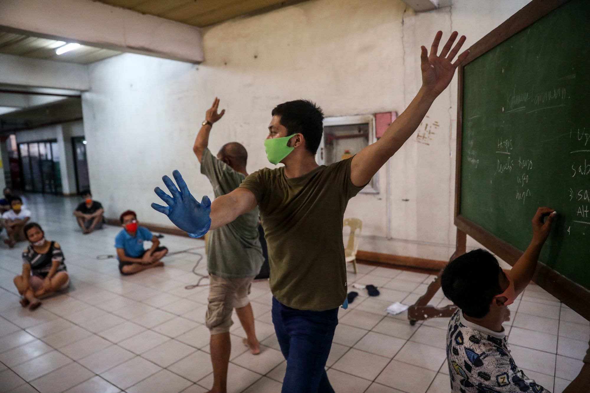Members of the Kalipaya Ministry, teach basic dance movements to homeless people who joined a theater workshop at the Paco Catholic School in Manila, Philippines.