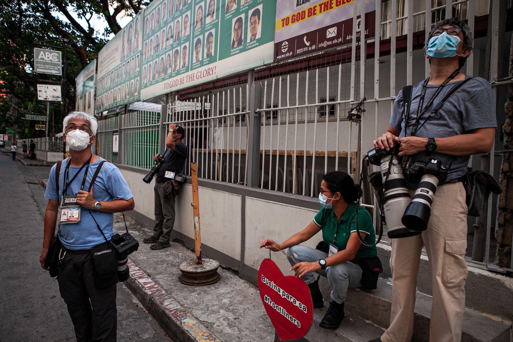 Photojournalists take time to relax in the middle of a coverage. (Photo by Mark Saludes)