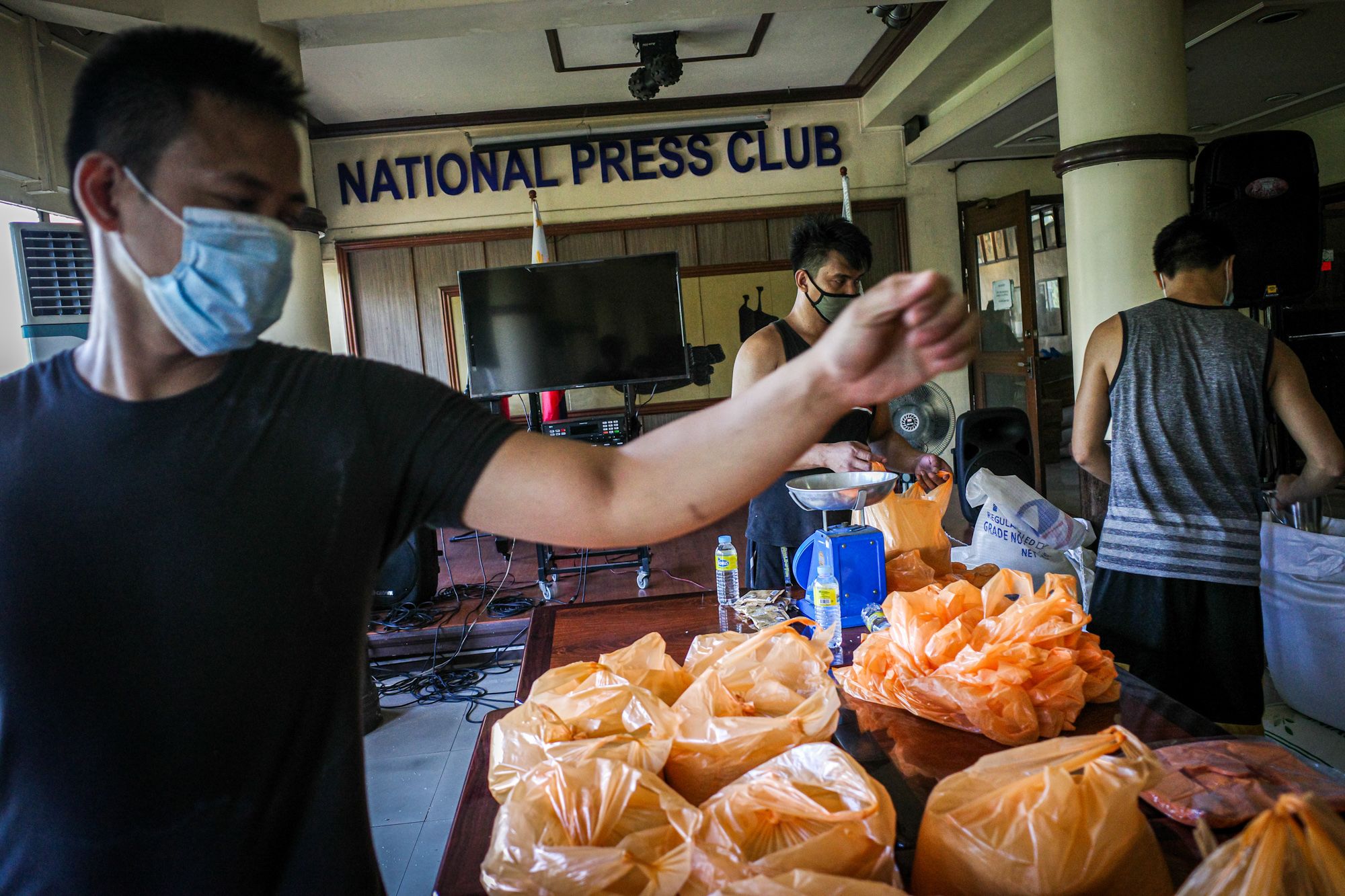 Volunteers pack relief goods for distribution to media workers at the National Press Club of the Philippines. (Photo by Mark Saludes)