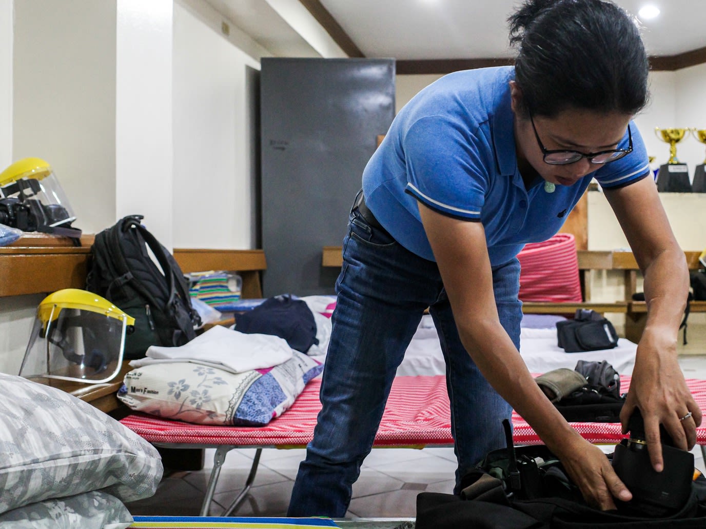 Photojournalist Maria Tan prepares her gear before another day of covering the pandemic in the Philippine capital. (Photo by Mark Saludes)