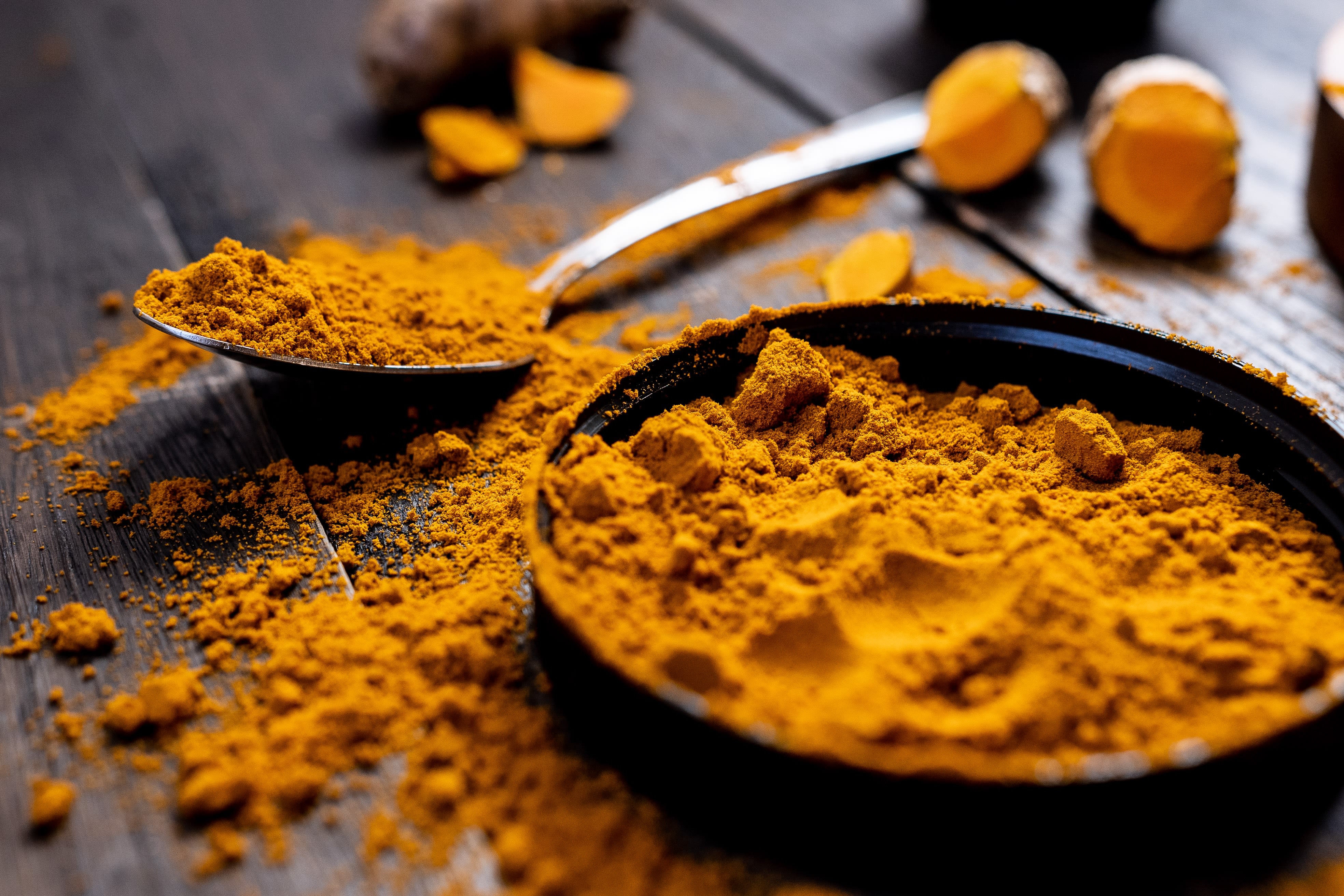 Turmeric powder on table and spoon
