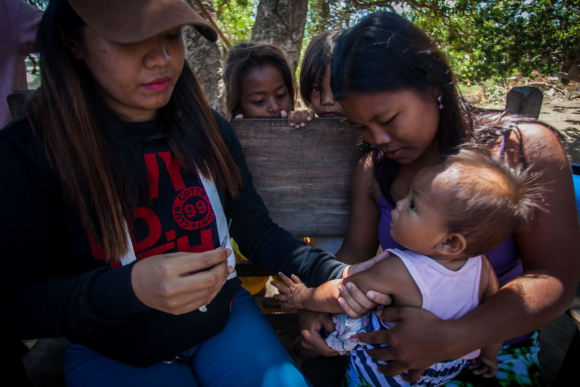 A tribal child receives a shot of vaccine in this photograph taken in 2019 in Cagayan province in the northern Philippines.