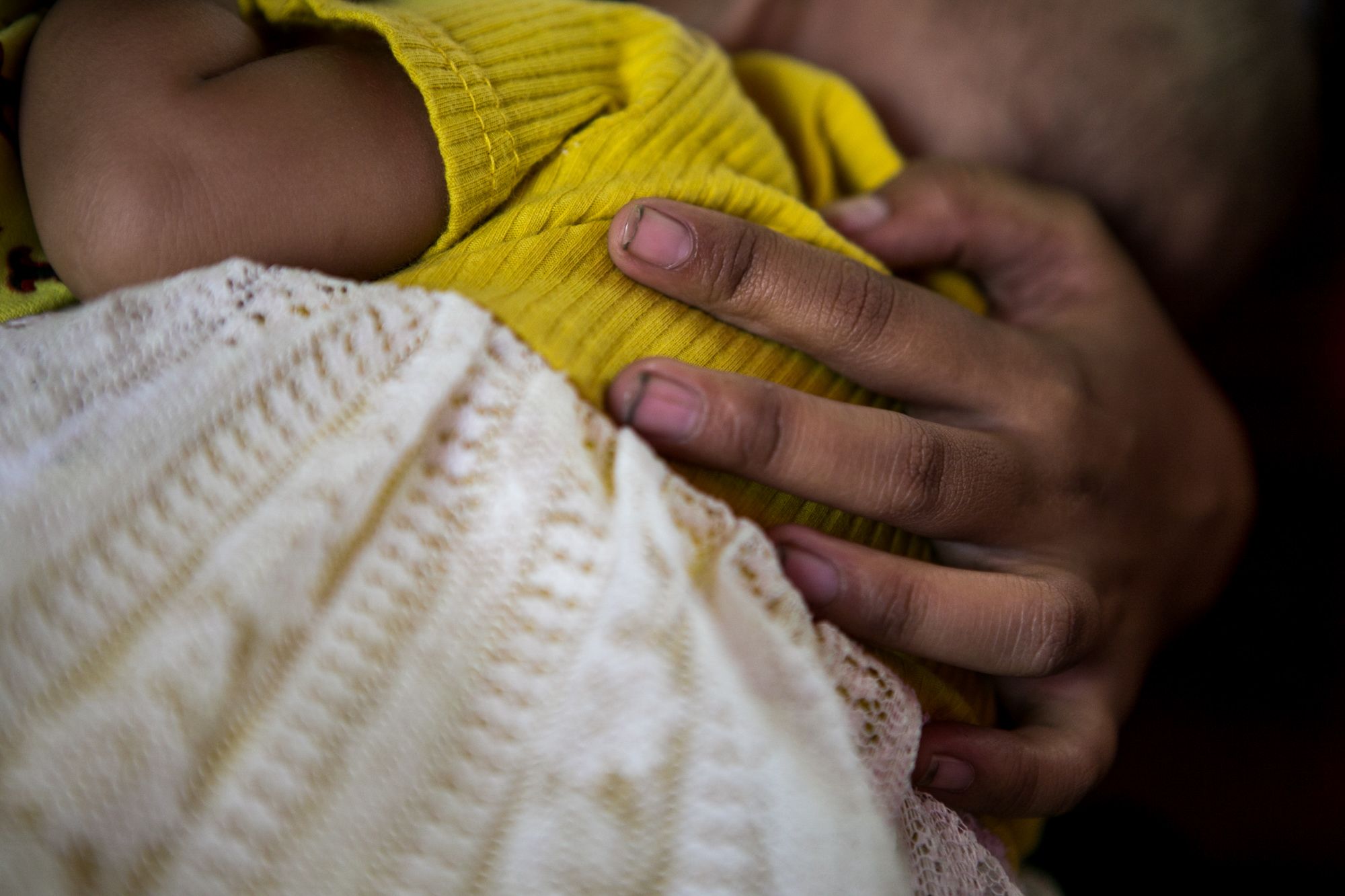 Lady holds her baby in this photo taken in February.