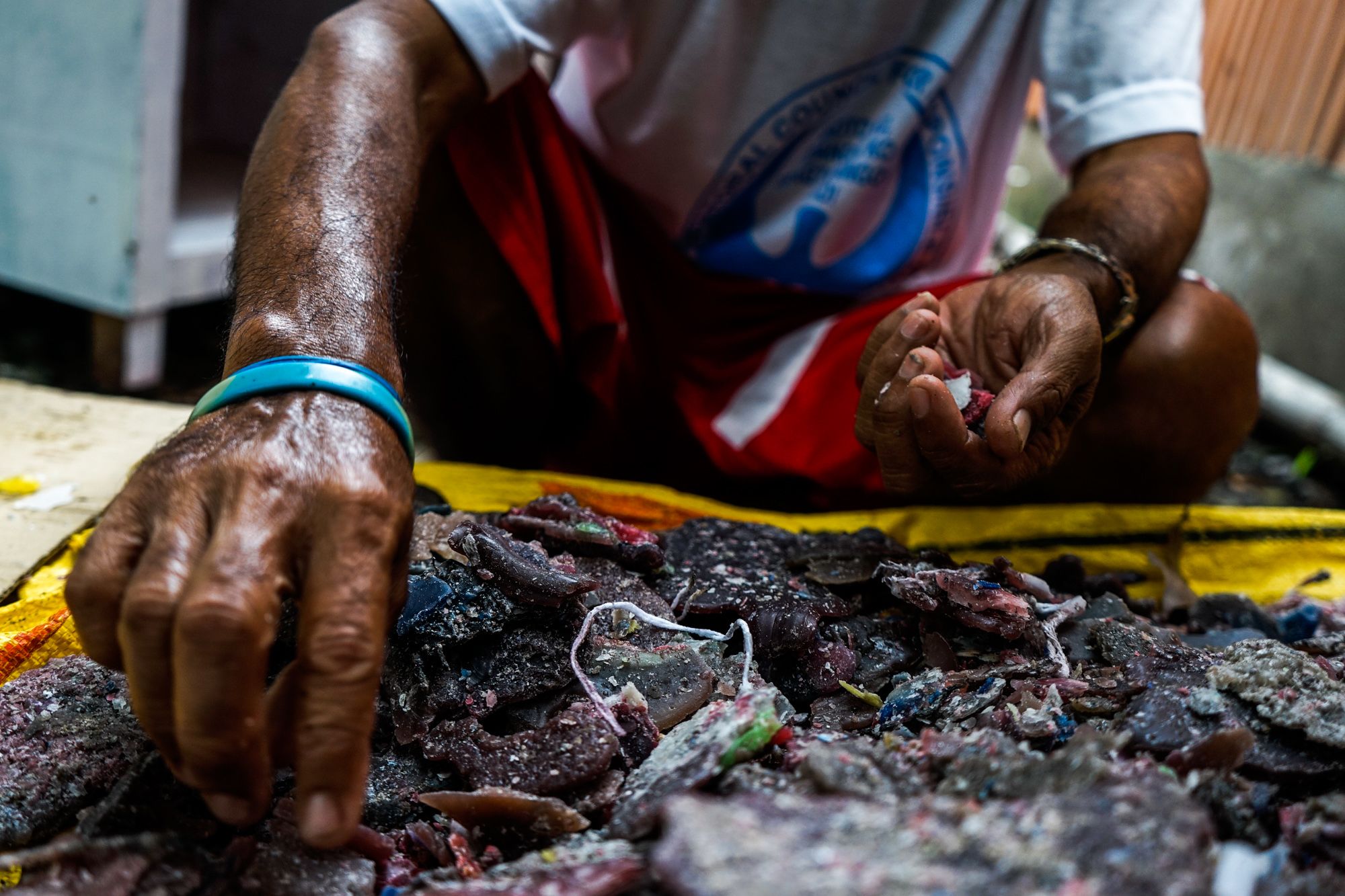 Used wax and half-burned candles are collected from churches for recycling.