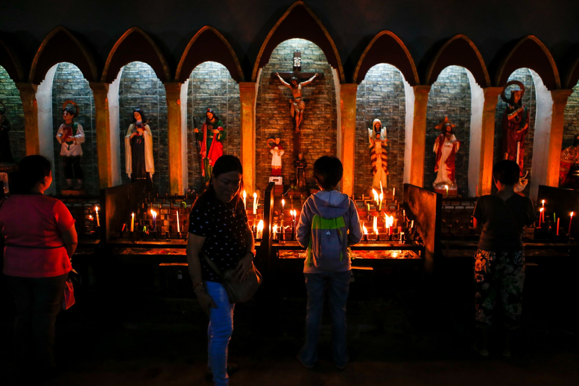Churchgoers light candles at the Gallery of Saints in the San Carlos Borromeo Cathedral in Negros island.