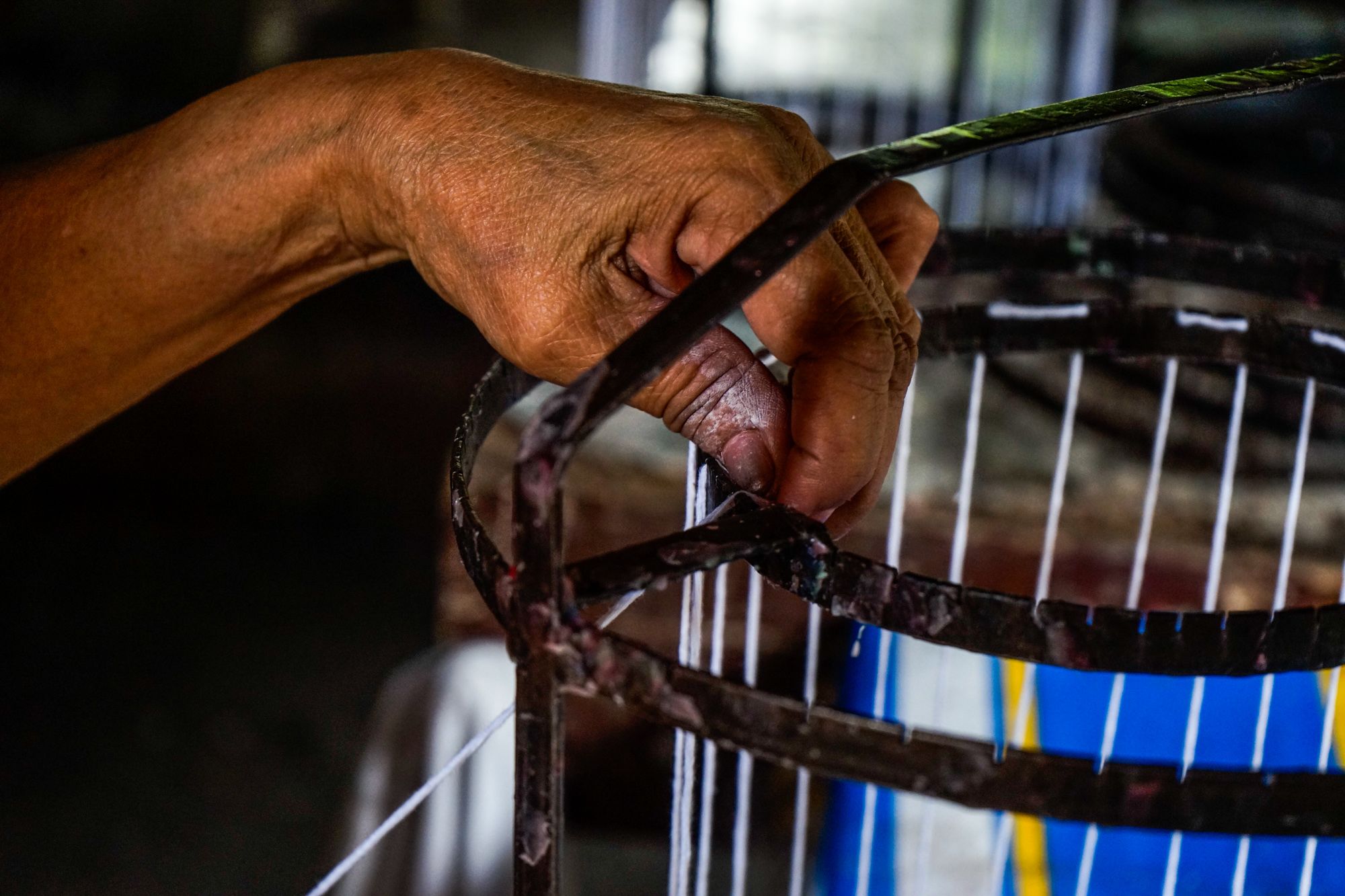 Arsenia Rabakal ties a cotton string before starting to mold the candles. The string will serve as the wick. Rabakal said she earns decent money in recycling candles.