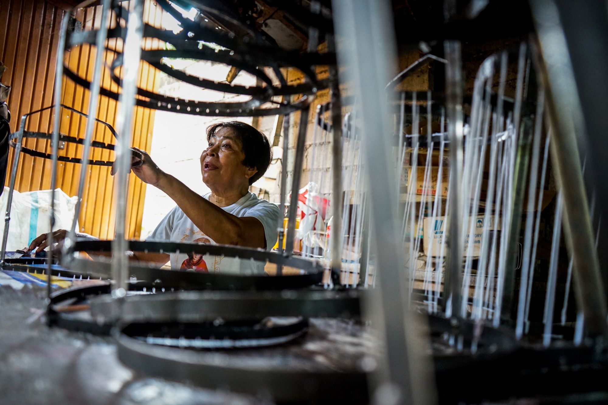 Arsenia Rabakal talks with a co-worker while preparing the candle molds in the Diocese of San Carlos in the central Philippine island of Negros.