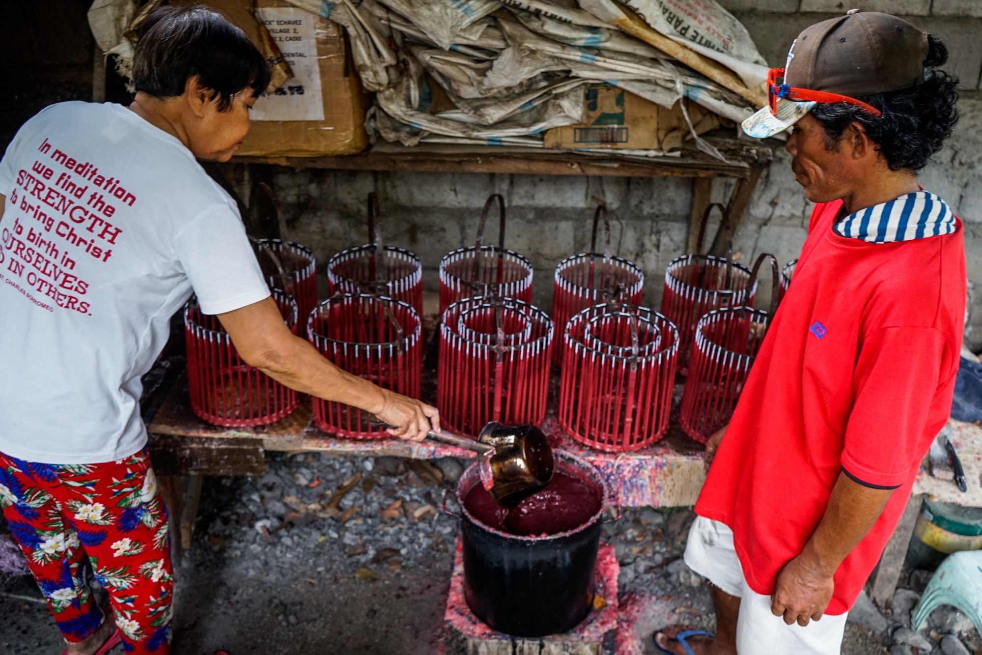 Church workers Arsenia Rabakal and Alfredo Dellagado are the diocese's chandlers who produce at least 3,000 recycled and new candles every two days.