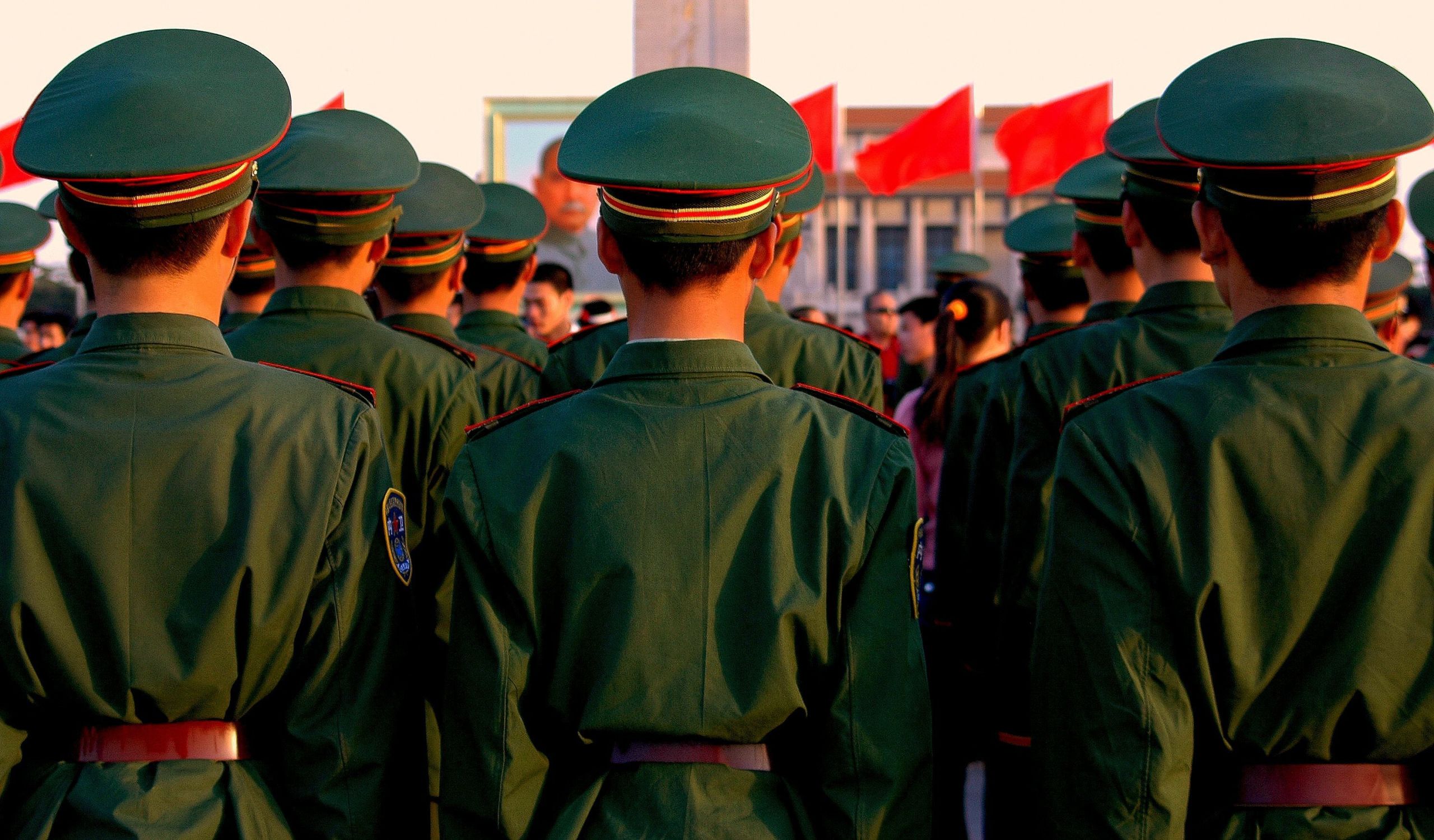 Chinese soldiers stand at attention during the evening lowering of the flag ritual in Tiananmen Square (Photo by LEE SNIDER PHOTO IMAGES / Shutterstock.com)