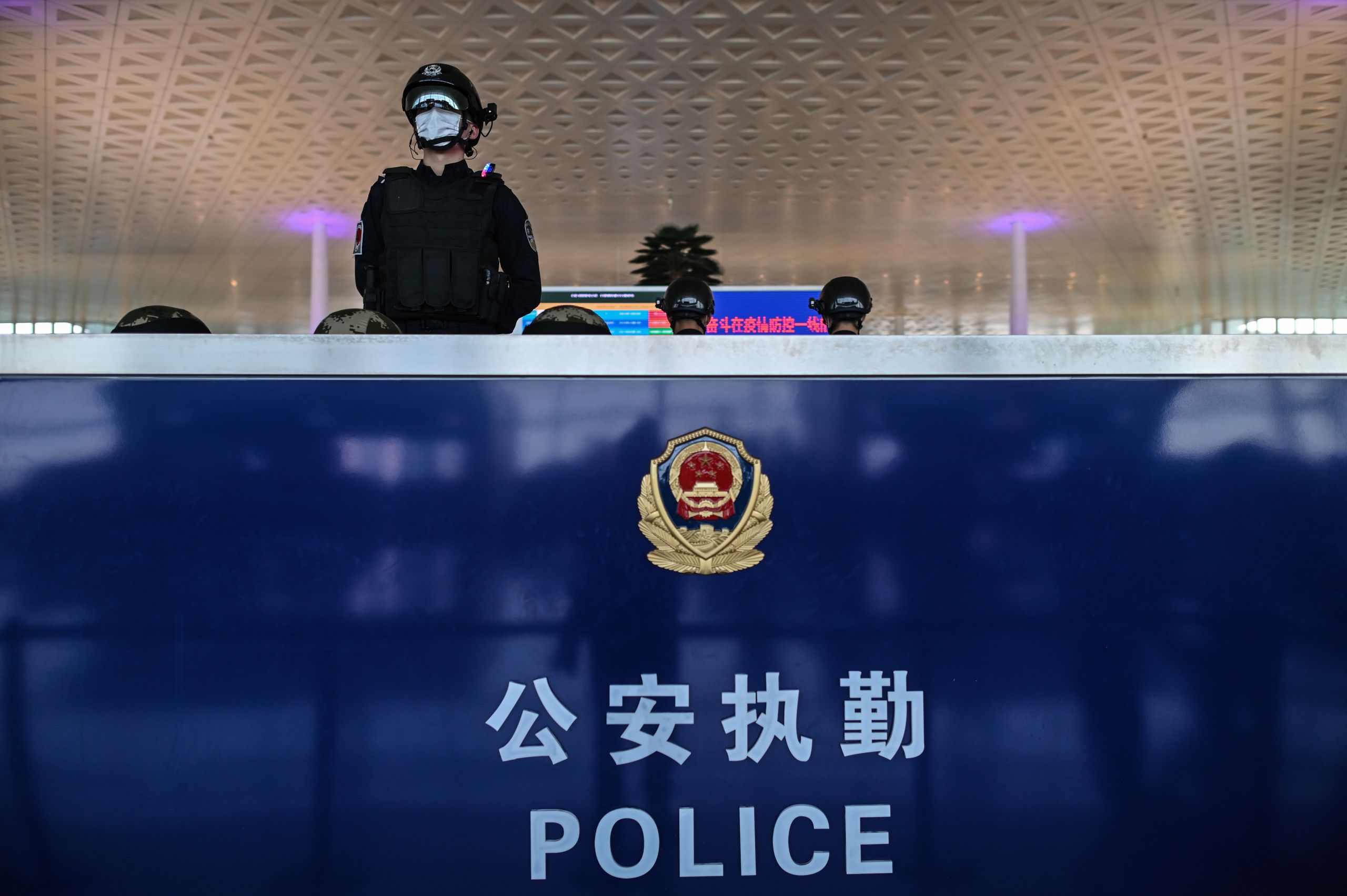 A police officer wearing a face mask stands guard at the Tianhe Airport after it was reopened in Wuhan in China's central Hubei province on April 8. (Photo by Hector Retamal/AFP)