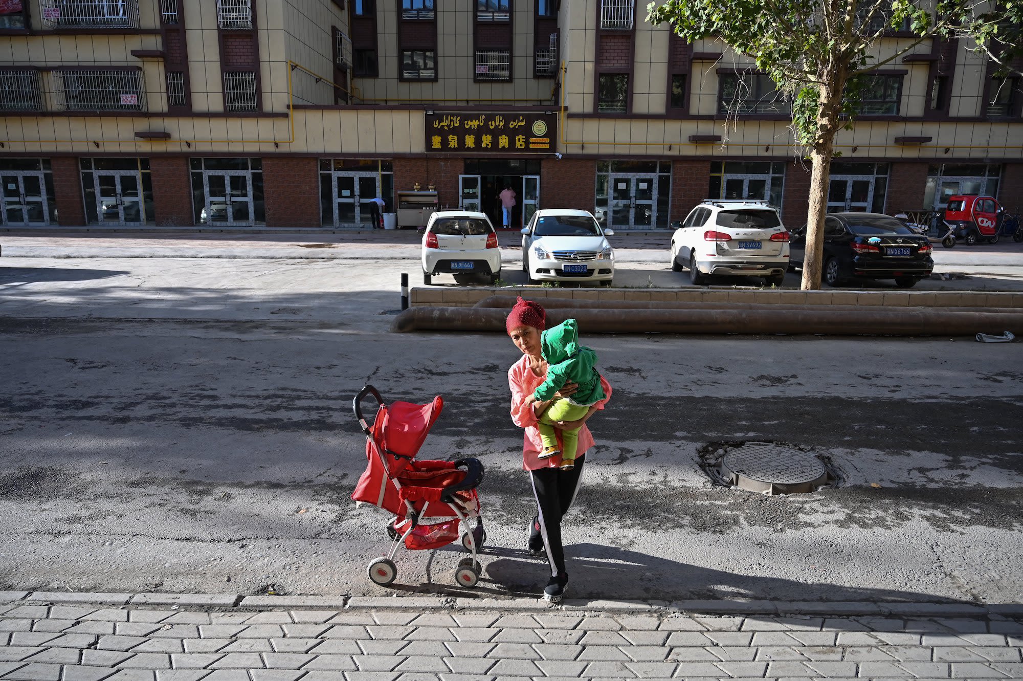 A woman walking in an ethnic Uyghur neighborhood in Aksu in the region of Xinjiang