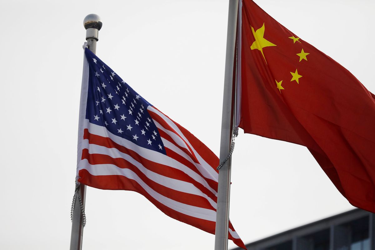 Chinese and US flags flutter outside a building