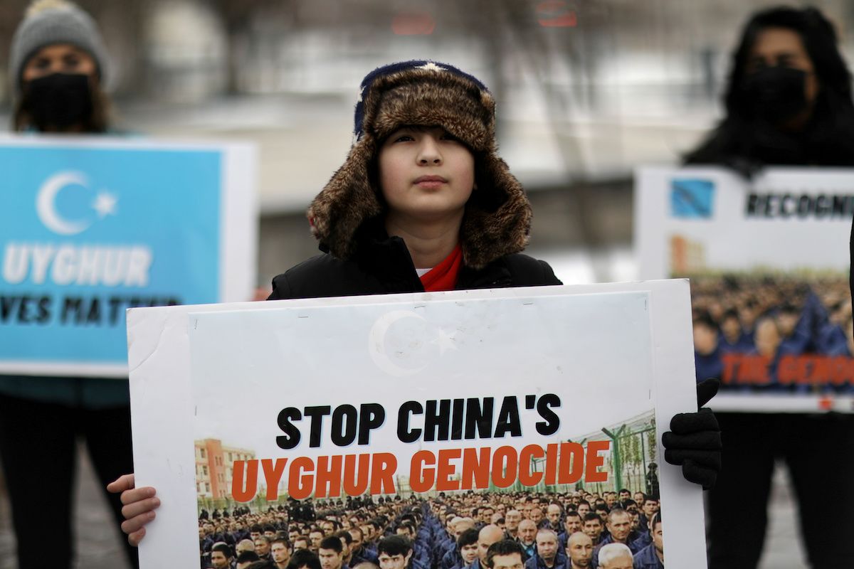 People take part in a rally against Uyghur genocide